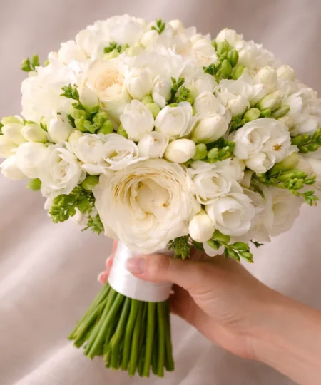 Romantyczny bukiet ślubny z białych frezji, jaskrów i róż wykonany przez Lu La Fleur – delikatna i elegancka florystyka ślubna.